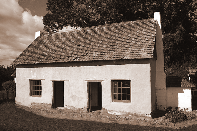 An old double fronted, single story cottage with a tiled roof