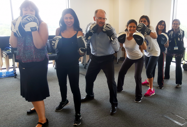 Colleagues take part in a boxing lesson.