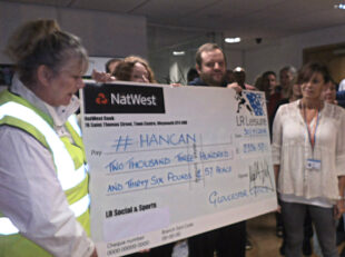 Handing over a cheque from Gloucester Office.