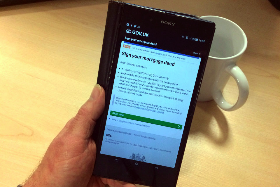 Smartphone showing 'Sign your mortgage deed' web page.