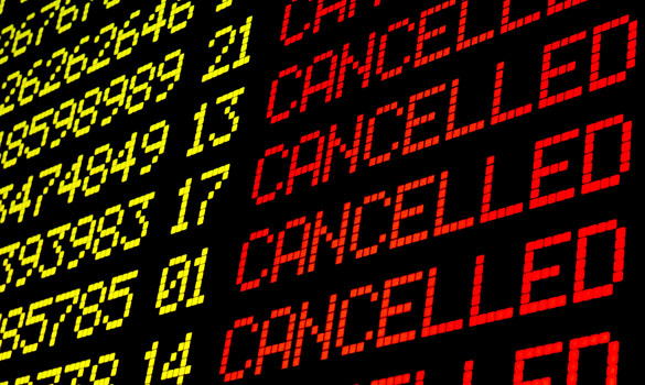 Cancelled flights on airport board panel.