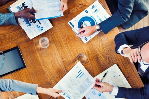 Team of people working at a table.