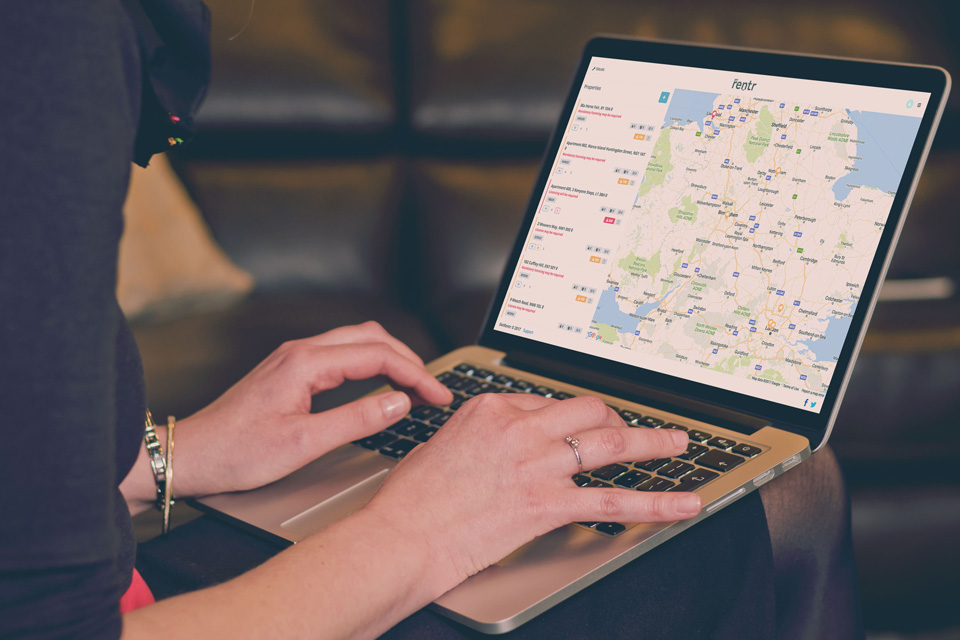 Woman using the GetRentr service on a laptop to search a map