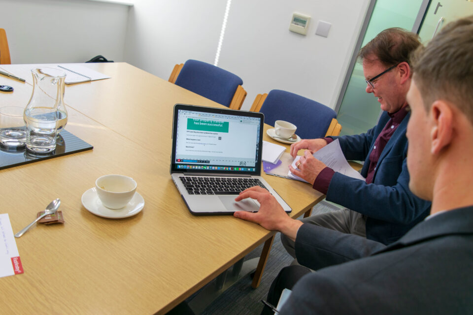 Digital Street Team members using a laptop in a meeting room.