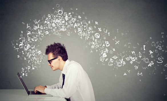 Man working at keyboard with data floating from screen