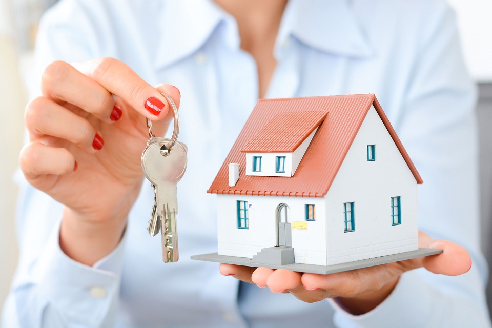 Real estate agent hand over property or new home keys to a customer