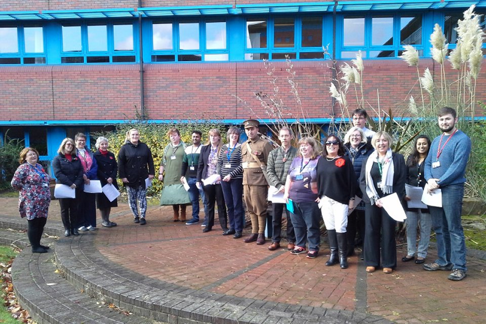 Telford choir standing in front of Telford office