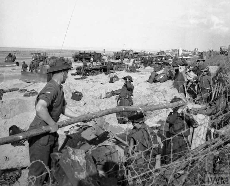 Troops digging in on a beach.