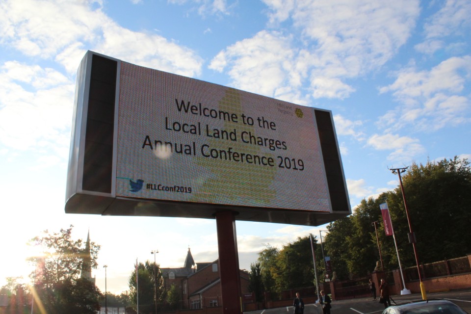 Sign saying 'Welcome to the Local Land Charges Annual Conference 2019'.