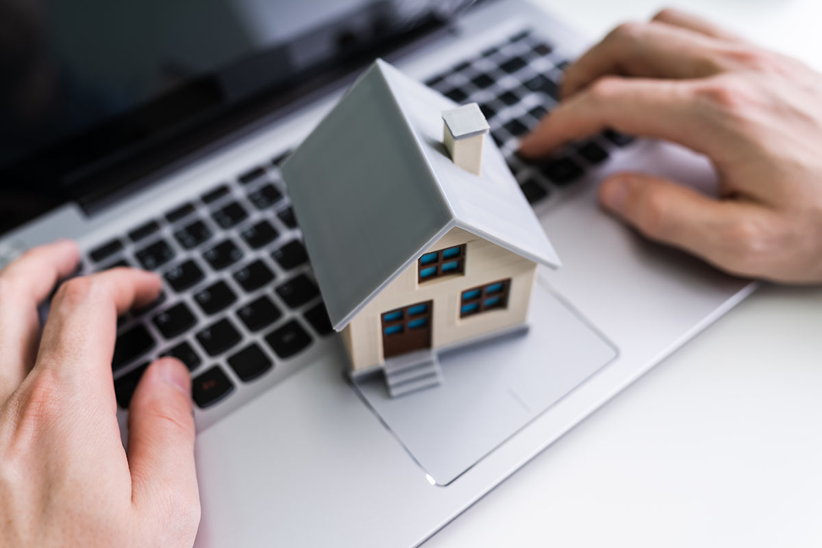 Model house sits on laptop keyboard.