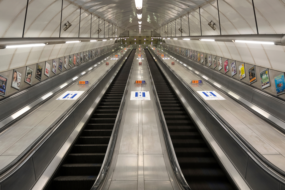 Empty escalator ascending steeply to the horizon.