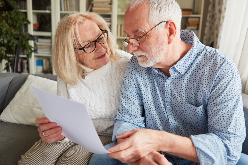 An elderly lady showing her son paperwork.