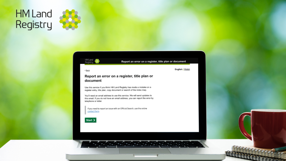 A laptop sitting on a desk with its screen displaying the report an error form.